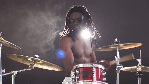 Awesome Black Man with Naked Skin Playing on Drums