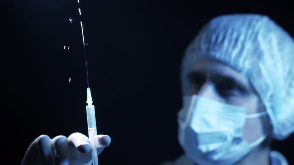 Doctor with a Syringe in His Hands