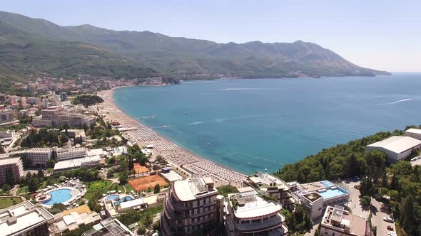 Drone View of Sun Loungers Under Umbrellas and Hotels on the Coast of Budva