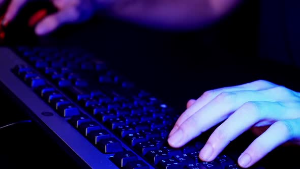 Gamer playing game with keyboard and mouse