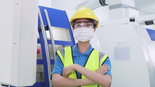 Portrait of Woman worker people wear protective mask in production factory due to covid pandemic