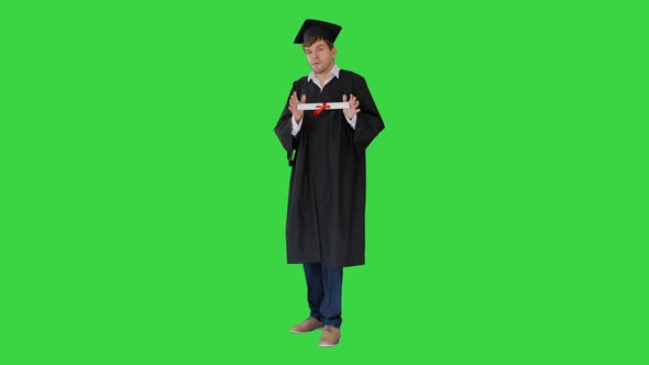 Male Student Graduation Robe Showing His Diploma Green Screen Chroma Key