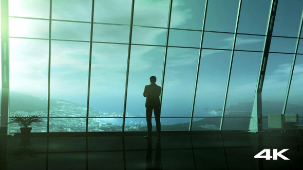 Businessman Standing Opposite The Window From Dawn To Dusk 4K