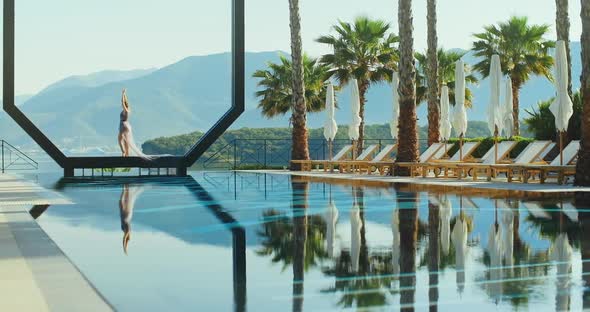 Young lady  standing over the pool on holidays. Travel vacation woman relaxing enjoying Montenegro