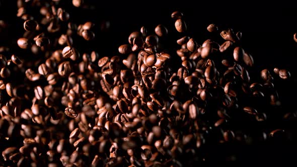 Super Slow Motion Shot of Exploding Premium Coffee Beans Isolated on Black at 1000Fps