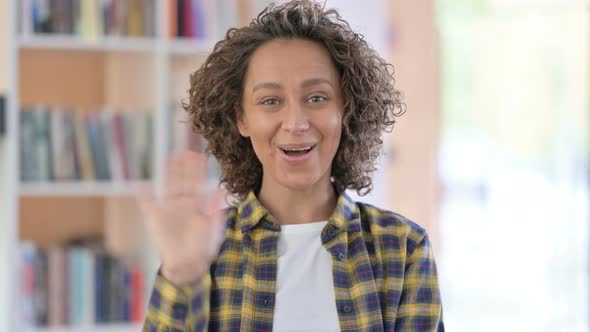 Portrait of Mixed Race Woman Waving, Welcoming