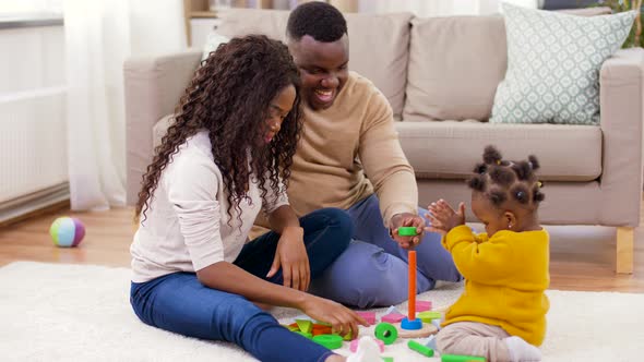 African Family Playing with Baby Daughter at Home