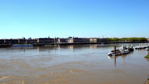 Place de la Bourse in Bordeaux France seen from the western shore of the Garonne river with river to
