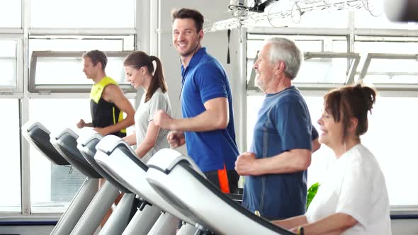 Young and Elderly People Running on Treadmill.