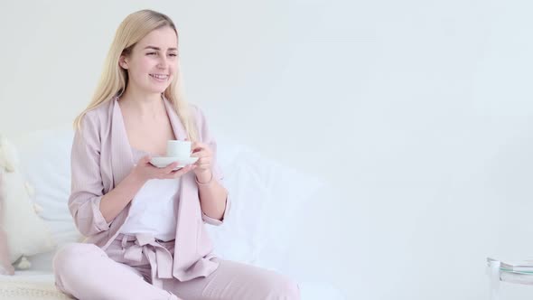 Beautiful Young Woman with Cup of Coffee in a Romantic Setting