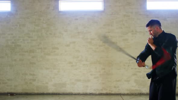 Kung fu fighter practicing martial arts with sword