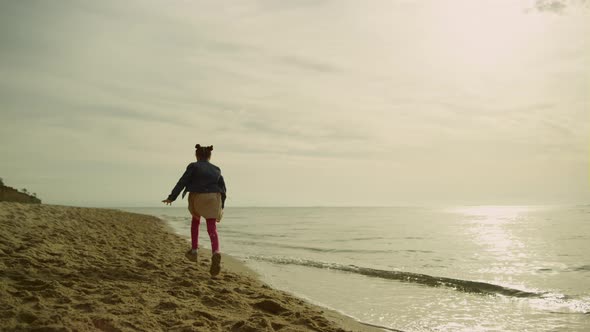 Girl Running Sand Sea at Sunset