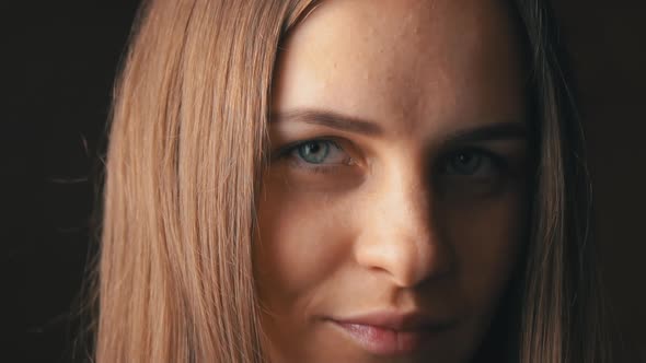 Face of a Beautiful Young Woman Looking and Smiling at the Camera