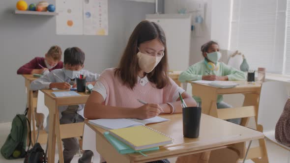 Portrait of Girl in Face Mask Posing During Lesson