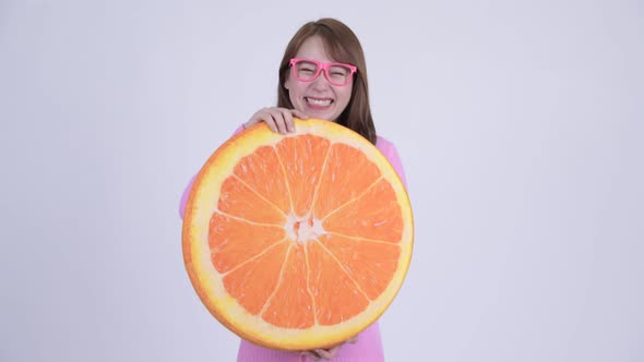 Young Happy Asian Nerd Woman with Orange Pillow As Healthy Concept