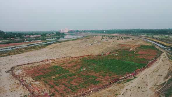 Aerial Ascending Shot of Taj Mahal Being Revealed and River Yamuna Flowing Alongside in Agra , Uttar