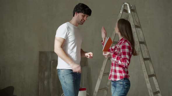 Family Couple Discussing a Renovation of a Home with Color Palette