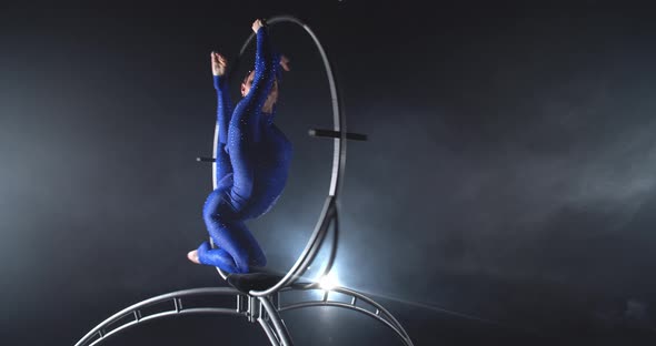 Flexible Beautiful Woman is Doing Gymnastics in a Big Hoop Studio Performance