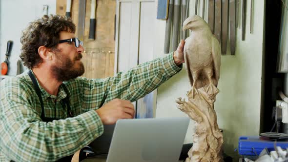 Craftsman examining a sculpture 4k