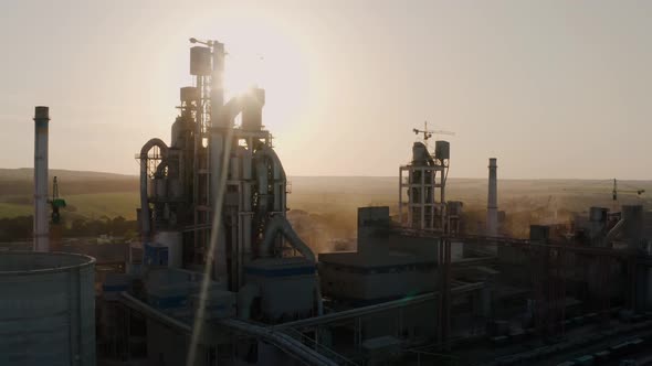 Aerial Drone Close Up Shot of Silhouette Cement Plant with High Factory Structure at Industrial