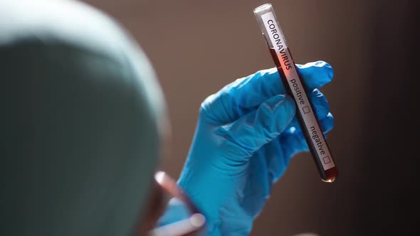 Doctor holding a coronavirus COVID-19 test tube