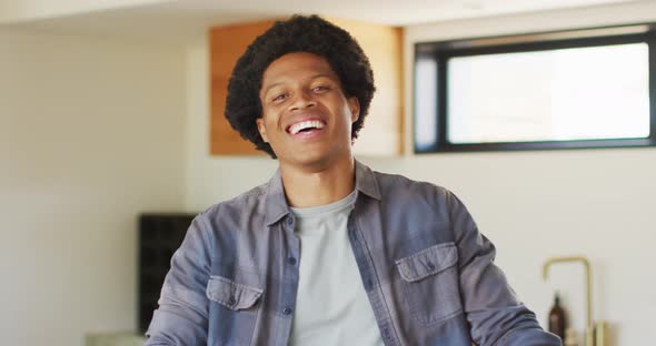 Happy african american man spending time alone at home