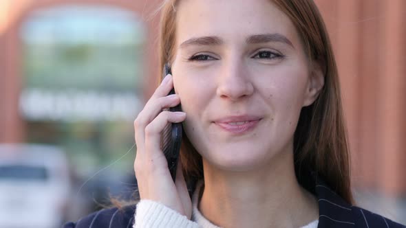 Happy Young Beautiful Woman Talking on Phone