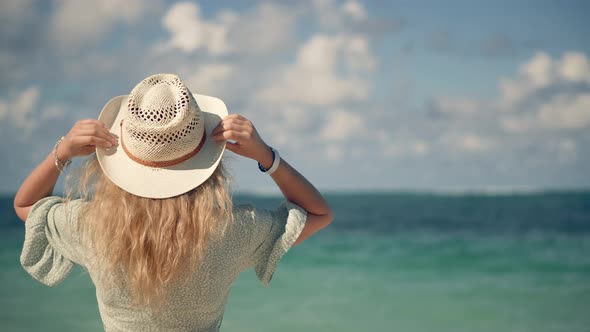 Girl Walking On Tropical Beah. Woman In Hat On Vacation. Woman On Summer Beach Near Ocean 
