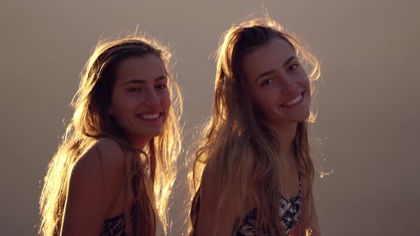 Twin teenage girls laughing and smiling