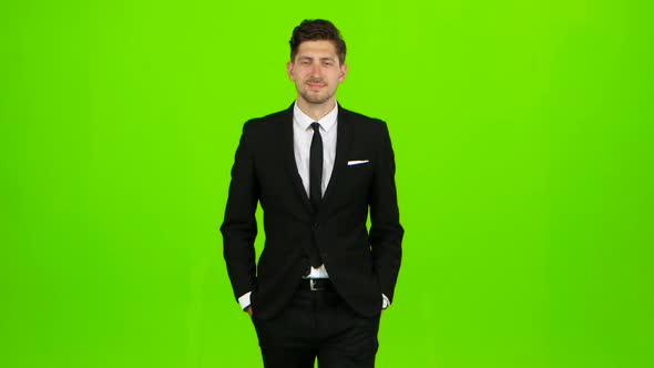Businessman Is Going To a Meeting and Waving Greetings. Green Screen