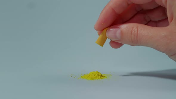 A woman poured a yellow medical capsule