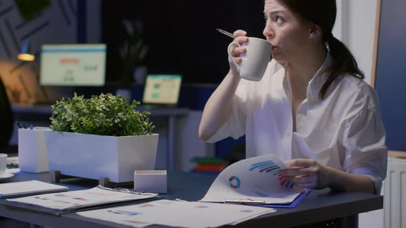 Focused Businesswoman Working Hard Overtime in Business Office Meeting Room