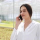 Worker Walking in a Greenhouse Using Mobile and Talking on Smartphone. Agricultural Engineer Working - VideoHive Item for Sale