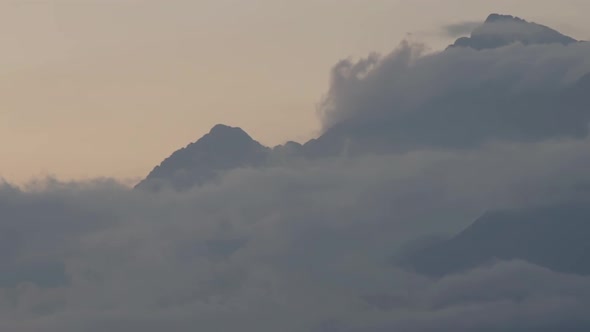 Timelapse of Dramatic Mountain Scenery with Clouds and Sun Rays. Aerial View of Hills Under Thick