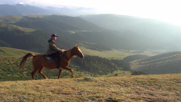 A Guy in a Cap Rides a Horse on Yellowgreen Hill