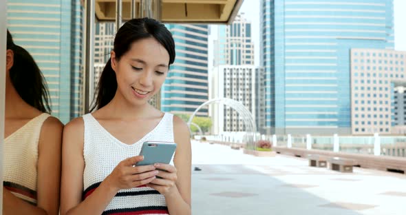 Woman using smart phone in the city