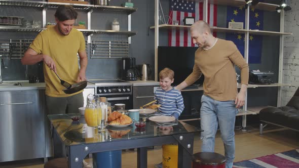 Same-Sex Couple with Kid Sitting Down for Breakfast