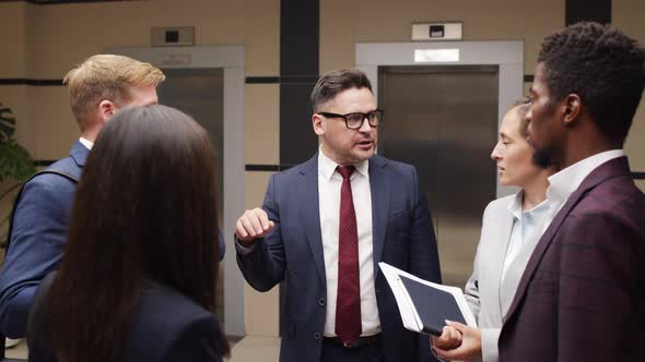 Businesspeople Having Conversation in Office Hall