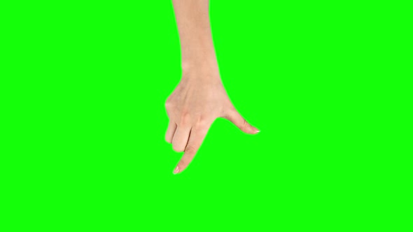 Female Hand Is Performing Pinch at Tablet Screen Gesture on Green Screen. Close Up