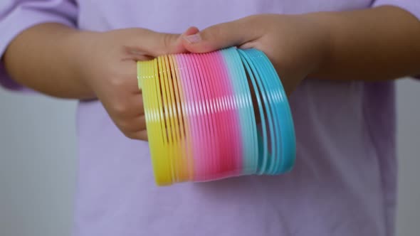 Slinky rainbow toy from the '90s. A multicolored children's spiral toy.
