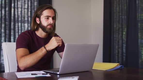 Caucasian man using laptop while working from home