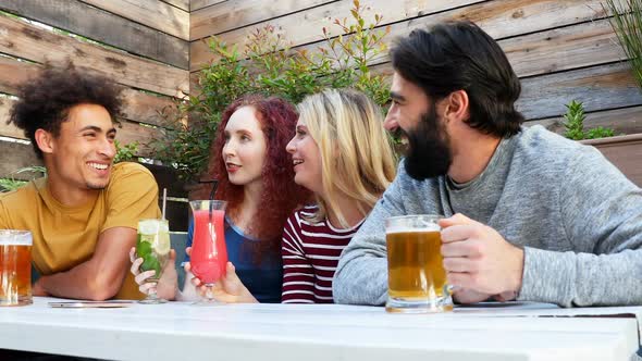 Friends interacting while having drink 4k