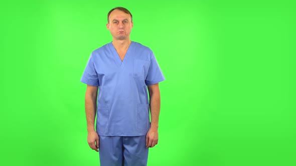 Medical Man Listens Carefully Information and Nods Head. Green Screen