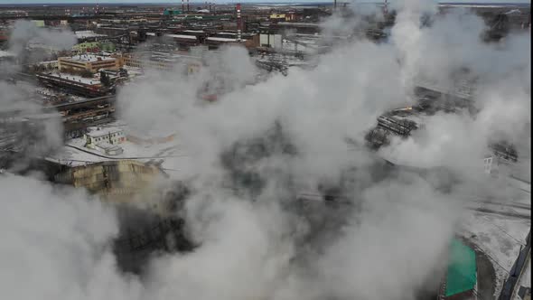 Smokestacks at Industrial Plant Polluting Atmosphere. Winter Aerial