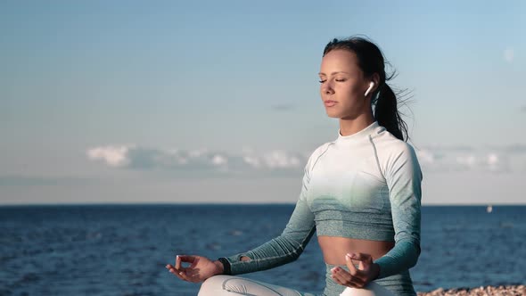 Happy Yoga Lady Meditating in Lotus Position at Sunset Sunny Beach Feeling Freedom Inspiration