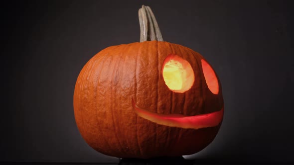 Colorful Flaming Cheerful Pumpkin, Jack O Lanterns, Spinning on Halloween. - Close up