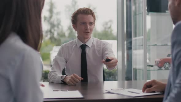 Happy Car Salesman Congratulating Customer on Purchase