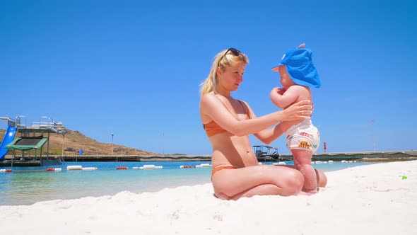 Emotions of a Little Happy Boy Who Is on the Beach for the First Time with Mom