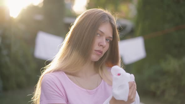 Young Slim Woman in Sunrays Cleaning Hands in Slow Motion Looking at Camera