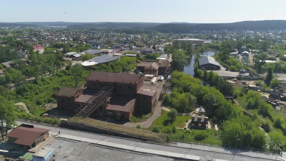 Aerial view of old red brick factory with an iron roof on the outskirts of the city 11